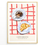 Load image into Gallery viewer, Italian breakfast poster with espresso and croissant on blue-patterned plates over a red checkered tablecloth, titled “Caffè Cornetto.”
