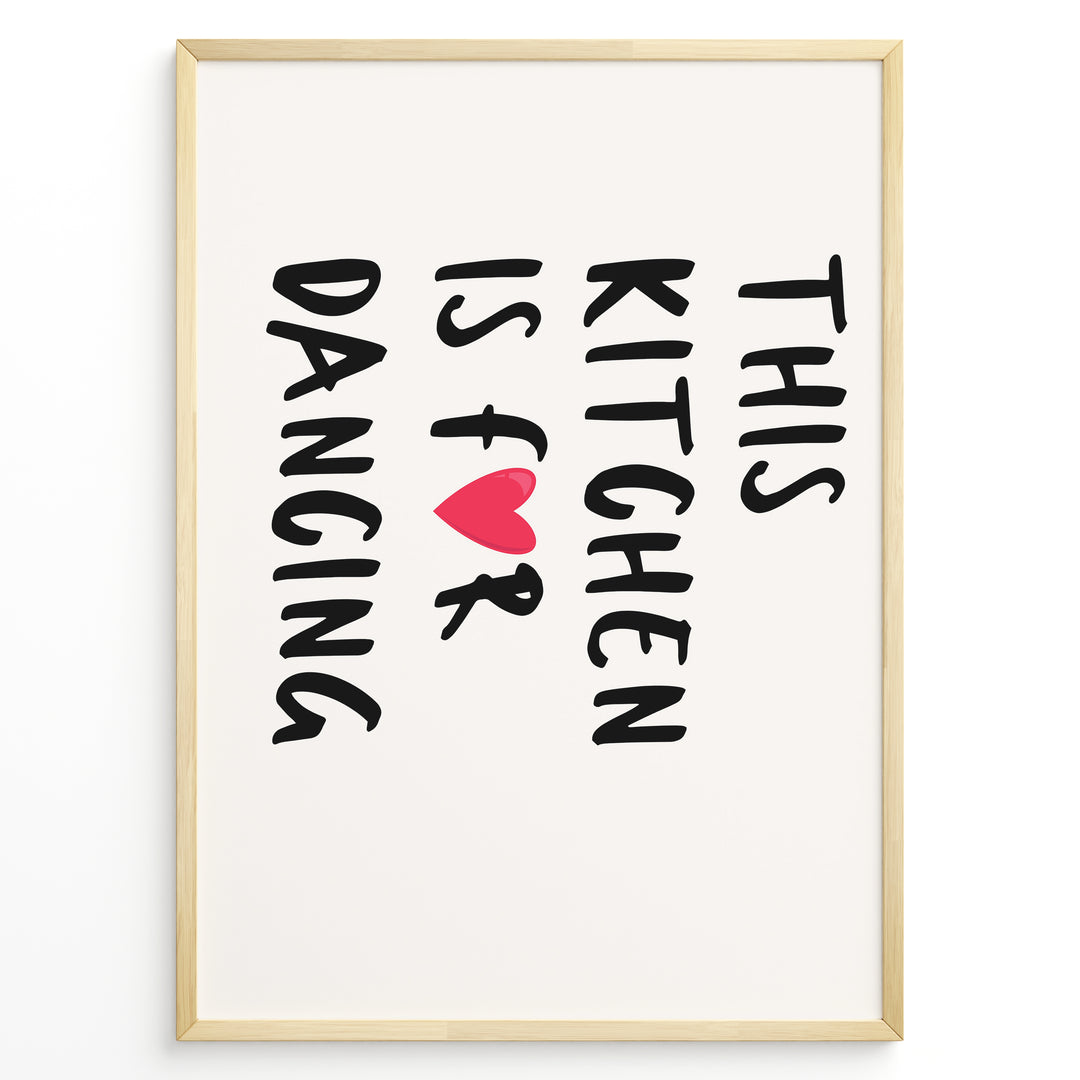 Minimalist poster with text “This Kitchen Is for Dancing” and a red heart in black font, framed in golden.