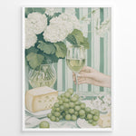 Load image into Gallery viewer, Elegant art print plakat of white wine glass, grapes, cheese, and hydrangeas on a green striped table with a hand holding a wine glass in a white frame.
