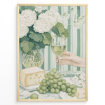 Load image into Gallery viewer, Elegant art print plakat of white wine glass, grapes, cheese, and hydrangeas on a green striped table with a hand holding a wine glass in a golden frame.
