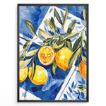 Load image into Gallery viewer, Mediterranean lemon wall art with yellow lemons and olive leaves on blue and white tile background, framed in black, ideal for kitchen or dining room décor.
