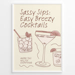 Load image into Gallery viewer, Minimalist cocktail-themed wall art with line drawings of martini and mojito glasses and the text “Sassy Sips: Easy Breezy Cocktails,” framed in black for kitchen or bar décor.
