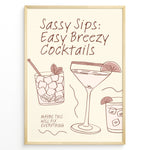 Load image into Gallery viewer, Minimalist cocktail-themed wall art with line drawings of martini and mojito glasses and the text “Sassy Sips: Easy Breezy Cocktails,” framed in black for kitchen or bar décor.

