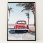 Load image into Gallery viewer, Plakat med vintage bil | Sommer og Strand Plakater | Denne plakat viser en vintage rød bil parkeret ved en strandvej med havet og palmetræer i baggrunden. Perfekt til dem, der elsker retro og strandstemning.
