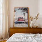 Load image into Gallery viewer, Plakat med vintage bil | Sommer og Strand Plakater | Denne plakat viser en vintage rød bil parkeret ved en strandvej med havet og palmetræer i baggrunden. Perfekt til dem, der elsker retro og strandstemning.

