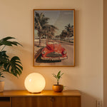 Load image into Gallery viewer, Plakat med vintage rød bil | Sommer og Strand Plakater | Denne plakat viser en klassisk rød cabriolet parkeret på en gade med palmer ved stranden. Perfekt til retro- og strandelskere.
