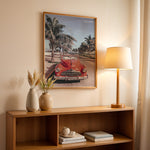 Load image into Gallery viewer, Plakat med vintage rød bil | Sommer og Strand Plakater | Denne plakat viser en klassisk rød cabriolet parkeret på en gade med palmer ved stranden. Perfekt til retro- og strandelskere.
