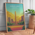 Load image into Gallery viewer, Buenos Aires Vintage Travel Plakat | Vintage Travel Poster | Denne plakat viser en illustration af et monument i Buenos Aires omgivet af moderne bygninger. Farverne går fra turkis til orange og gul, som skaber en livlig atmosfære.
