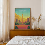 Load image into Gallery viewer, Buenos Aires Vintage Travel Plakat | Vintage Travel Poster | Denne plakat viser en illustration af et monument i Buenos Aires omgivet af moderne bygninger. Farverne går fra turkis til orange og gul, som skaber en livlig atmosfære.

