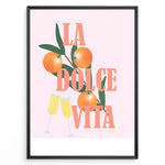 Load image into Gallery viewer, Stylish La Dolce Vita poster with oranges, green leaves, and champagne glasses on a pink background, framed as Italian-inspired wall art.
