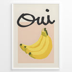 Load image into Gallery viewer, Modern art poster featuring the word “Oui” in bold black text above a bunch of yellow bananas on a soft pink background, framed as French kitchen wall décor.
