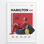 Load image into Gallery viewer, Framed Hamilton 44 Scuderia Ferrari F1 poster showing the driver in a red suit leaning on tires, holding a yellow helmet, with signature and career stats.
