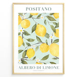 Load image into Gallery viewer, Positano lemon tree poster with yellow lemons, green leaves, and white flowers on a light blue background in a golden frame.
