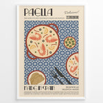 Load image into Gallery viewer, Vintage Spanish paella poster with illustrated pan of rice, prawns, and lemon slices on a blue patterned background in a white frame.
