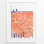 Load image into Gallery viewer, Le Matin poster with minimalist croissant illustration in orange and blue text on a white background in a white frame.
