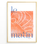 Load image into Gallery viewer, Le Matin poster with minimalist croissant illustration in orange and blue text on a white background in a golden frame.
