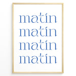 Load image into Gallery viewer, Minimalist French typography poster with the word “matin” repeated four times in blue text on a white background in a golden frame.
