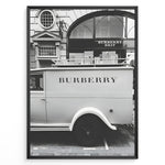 Load image into Gallery viewer, Fashion Plakat | Burberry Vintage Van &amp; Storefront – Black &amp; White Fashion Poster Plakaty.dk | Black and white photo of a vintage Burberry van parked in front of a Burberry Brit boutique, combining retro automotive style with a luxury storefront backdrop.
