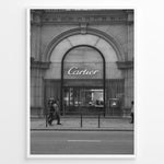 Load image into Gallery viewer, Fashion Plakat | Cartier Boutique Street View – Black &amp; White Luxury Fashion Poster Plakaty.dk | Black and white photograph of a Cartier boutique storefront with a grand arched entrance and pedestrians walking by on a city street.
