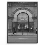 Load image into Gallery viewer, Fashion Plakat | Cartier Boutique Street View – Black &amp; White Luxury Fashion Poster Plakaty.dk | Black and white photograph of a Cartier boutique storefront with a grand arched entrance and pedestrians walking by on a city street.
