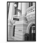 Load image into Gallery viewer, Fashion Plakat | Chanel Boutique Exterior – Monte Carlo, Monaco Plakaty.dk | Black and white photo of the Chanel storefront in Monte Carlo, Monaco, showcasing ornate architecture with columns, balconies, and a hanging sign.
