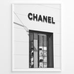 Load image into Gallery viewer, Fashion Plakat | Chanel Boutique Storefront – Minimalist Black and White Fashion Photography Plakaty.dk | Black and white photo of a Chanel storefront with window display showcasing handbags and luxury items
