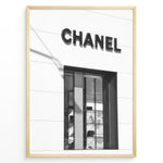 Load image into Gallery viewer, Fashion Plakat | Chanel Boutique Storefront – Minimalist Black and White Fashion Photography Plakaty.dk | Black and white photo of a Chanel storefront with window display showcasing handbags and luxury items
