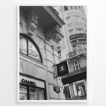 Load image into Gallery viewer, Fashion Plakat | Chanel Boutique Vienna Black &amp; White Architectural Poster Plakaty.dk | Black and white photo of a Chanel store in a European city with ornate architecture and a Chanel flag sign.
