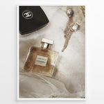 Load image into Gallery viewer, Fashion Plakat | Chanel Gabrielle Perfume Flat Lay with Earrings and Compact – Luxury Beauty Print Plakaty.dk | Flat lay image of Chanel Gabrielle perfume, a black Chanel compact, and gold statement earrings on soft white fabric.
