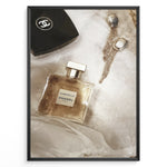 Load image into Gallery viewer, Fashion Plakat | Chanel Gabrielle Perfume Flat Lay with Earrings and Compact – Luxury Beauty Print Plakaty.dk | Flat lay image of Chanel Gabrielle perfume, a black Chanel compact, and gold statement earrings on soft white fabric.
