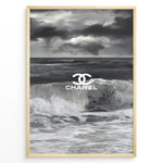 Load image into Gallery viewer, Fashion Plakat | Chanel Ocean Wave Black &amp; White Fashion Poster Plakaty.dk | Black and white ocean wave poster with the Chanel logo centered over crashing waves and a stormy sky.
