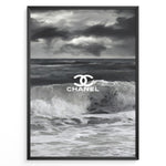 Load image into Gallery viewer, Fashion Plakat | Chanel Ocean Wave Black &amp; White Fashion Poster Plakaty.dk | Black and white ocean wave poster with the Chanel logo centered over crashing waves and a stormy sky.
