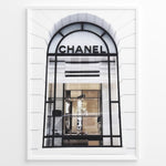 Load image into Gallery viewer, Fashion Plakat | Chanel Storefront Window – Fashion Photography Print Plakaty.dk | Photograph of a Chanel boutique storefront window with elegant black framing and luxury fashion items on display.
