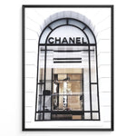 Load image into Gallery viewer, Fashion Plakat | Chanel Storefront Window – Fashion Photography Print Plakaty.dk | Photograph of a Chanel boutique storefront window with elegant black framing and luxury fashion items on display.
