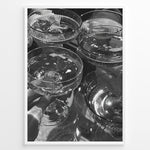 Load image into Gallery viewer, Fashion Plakat | Cheers in Black &amp; White: Luxe Champagne Coupes Wall Art Plakaty.dk | Black and white photo of multiple champagne coupe glasses being raised in a celebratory toast, reflecting light and bubbles.
