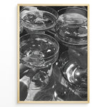 Load image into Gallery viewer, Fashion Plakat | Cheers in Black &amp; White: Luxe Champagne Coupes Wall Art Plakaty.dk | Black and white photo of multiple champagne coupe glasses being raised in a celebratory toast, reflecting light and bubbles.
