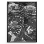 Load image into Gallery viewer, Fashion Plakat | Cheers in Black &amp; White: Luxe Champagne Coupes Wall Art Plakaty.dk | Black and white photo of multiple champagne coupe glasses being raised in a celebratory toast, reflecting light and bubbles.
