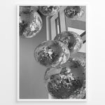 Load image into Gallery viewer, Fashion Plakat | Cluster of Disco Balls in Natural Light Plakaty.dk | Black and white photo of multiple hanging disco balls reflecting natural light near large windows
