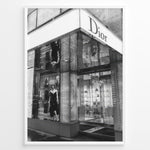 Load image into Gallery viewer, Fashion Plakat | Dior Flagship Storefront – New York City Plakaty.dk | Black and white image of the Dior flagship store in New York City, featuring a glass facade, reflective surfaces, and a mannequin in an elegant outfit.

