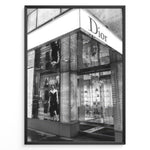 Load image into Gallery viewer, Fashion Plakat | Dior Flagship Storefront – New York City Plakaty.dk | Black and white image of the Dior flagship store in New York City, featuring a glass facade, reflective surfaces, and a mannequin in an elegant outfit.
