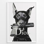 Load image into Gallery viewer, Fashion Plakat | Dior Guard Dog – Bold Fashion Art Print Plakaty.dk | Black and white image of a Doberman dog holding a handgun in its mouth, wearing a spiked collar with the Dior logo, against a plain background.
