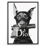 Load image into Gallery viewer, Fashion Plakat | Dior Guard Dog – Bold Fashion Art Print Plakaty.dk | Black and white image of a Doberman dog holding a handgun in its mouth, wearing a spiked collar with the Dior logo, against a plain background.
