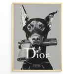Load image into Gallery viewer, Fashion Plakat | Dior Guard Dog Poster – Bold Fashion Statement Wall Art Plakaty.dk | Black and white image of a Doberman dog holding a handgun in its mouth, wearing a Dior collar, with &quot;Dior&quot; text overlayed – a bold, edgy luxury fashion print.
