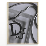 Load image into Gallery viewer, Fashion Plakat | Dior Pendant Necklace – Elegant Black &amp; White Fashion Print Plakaty.dk | Black and white close-up image of a Dior pendant necklace with a metallic chain, showcasing luxury jewelry on a textured background.
