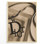 Load image into Gallery viewer, Fashion Plakat | Dior Sepia Necklace Charm – Vintage-Inspired Fashion Wall Art Plakaty.dk | Sepia-toned Dior necklace charm with close-up detail on a textured surface, styled as vintage fashion wall art.
