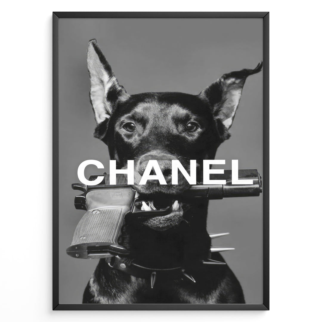 Fashion Plakat | Edgy Chanel-Inspired Art Featuring Dog with Gun Plakaty.dk | Black dog with spiked collar holding a handgun in its mouth, with the word "CHANEL" overlaid in bold white text.