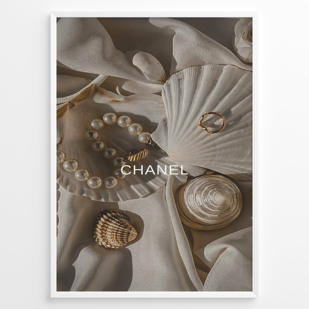 Fashion Plakat | Elegant Chanel-Inspired Flat Lay with Seashells and Jewelry Plakaty.dk | Flat lay of elegant seashells, a pearl bracelet, and gold jewelry on soft ivory fabric with the Chanel logo centered.