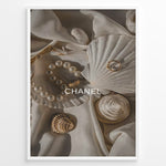 Load image into Gallery viewer, Fashion Plakat | Elegant Chanel-Inspired Flat Lay with Seashells and Jewelry Plakaty.dk | Flat lay of elegant seashells, a pearl bracelet, and gold jewelry on soft ivory fabric with the Chanel logo centered.
