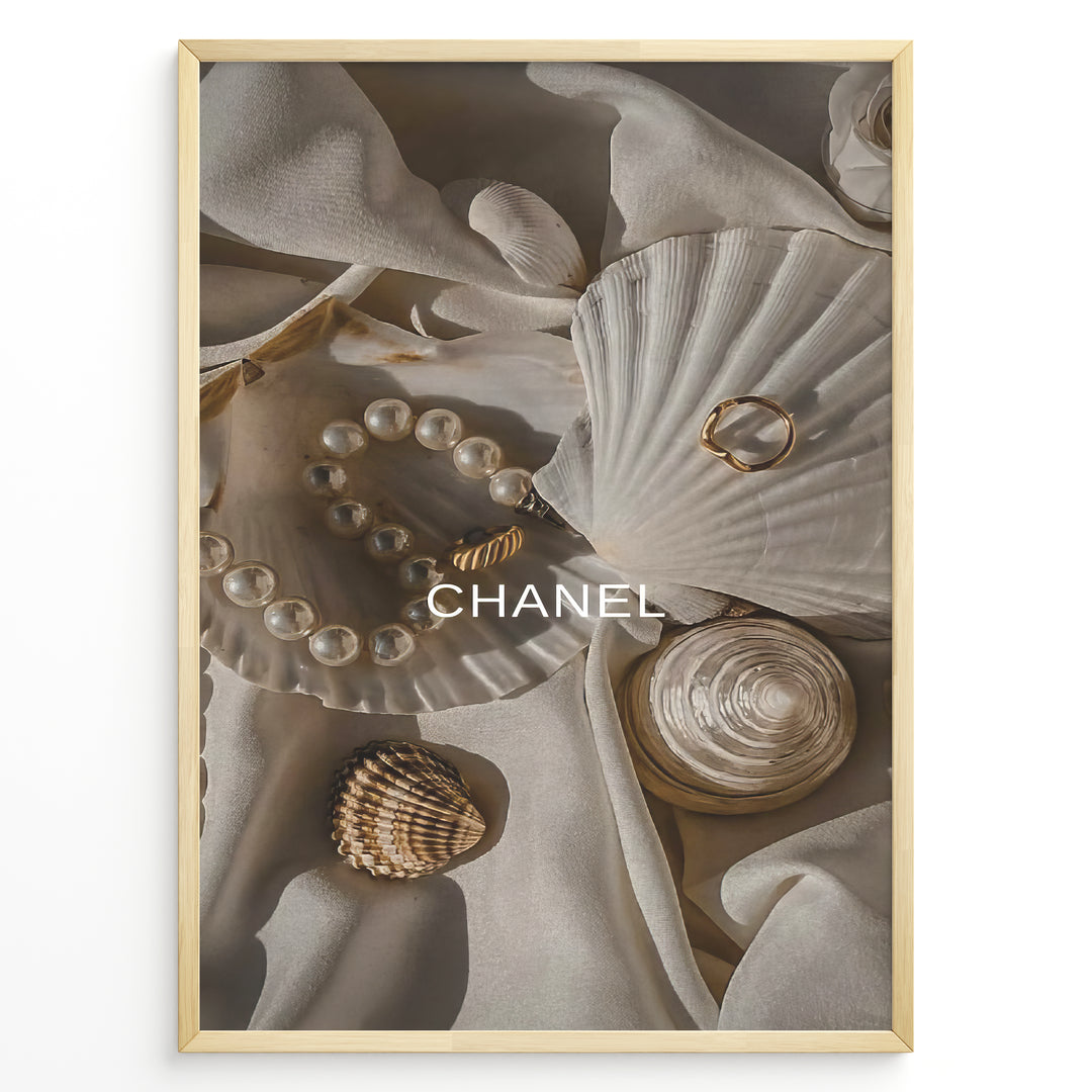 Fashion Plakat | Elegant Chanel-Inspired Flat Lay with Seashells and Jewelry Plakaty.dk | Flat lay of elegant seashells, a pearl bracelet, and gold jewelry on soft ivory fabric with the Chanel logo centered.