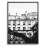 Load image into Gallery viewer, Fashion Plakat | Elegant Woman Relaxing on Parisian Balcony – Black and White Photography Plakaty.dk | Black and white photo of a woman relaxing on a Parisian balcony with classic building architecture in the background
